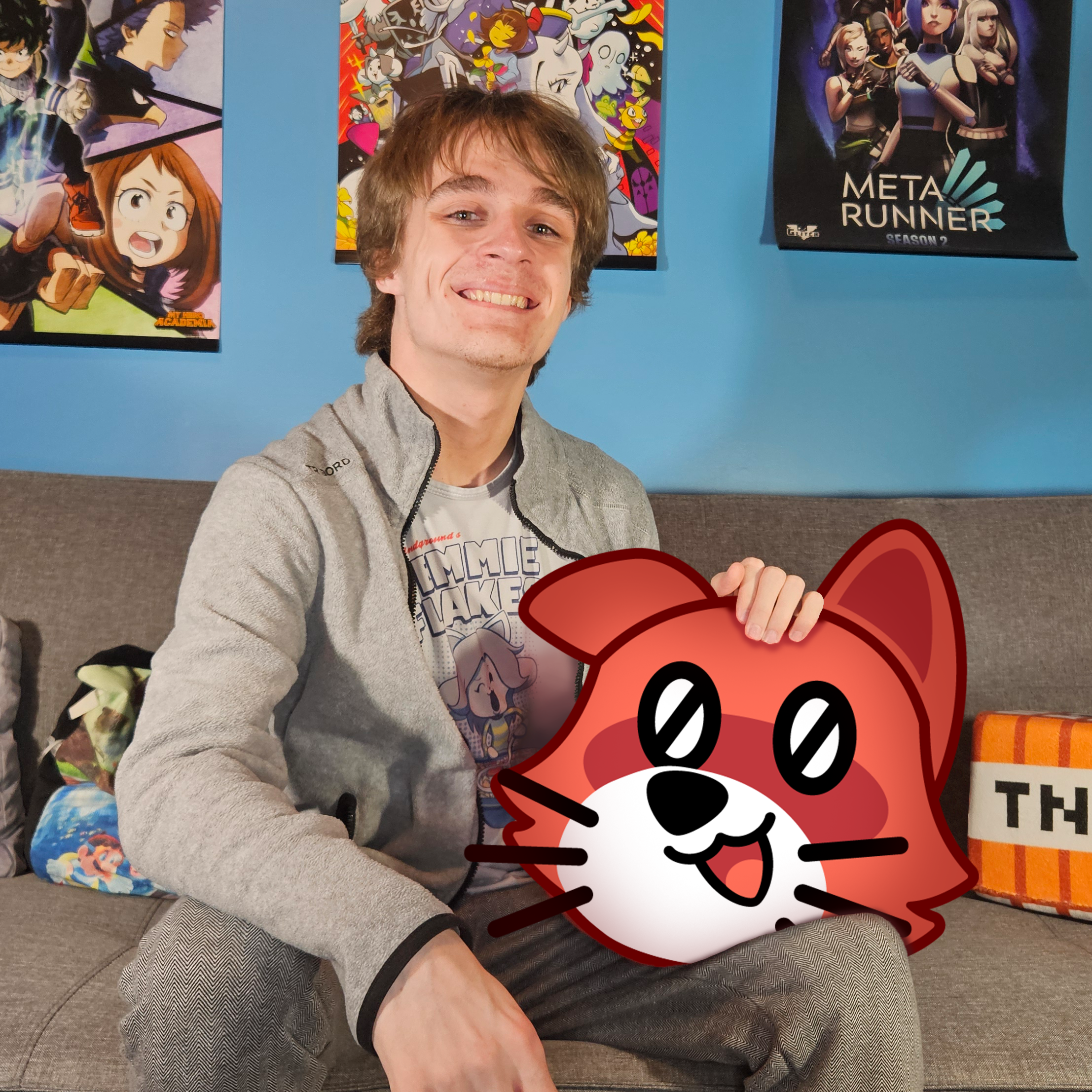 A picture of Gaël and the animated cat mascot of the Grand Programmathon, Ludo.